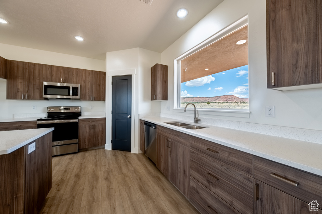 Kitchen featuring sink, appliances with stainless steel finishes, and light hardwood / wood-style floors