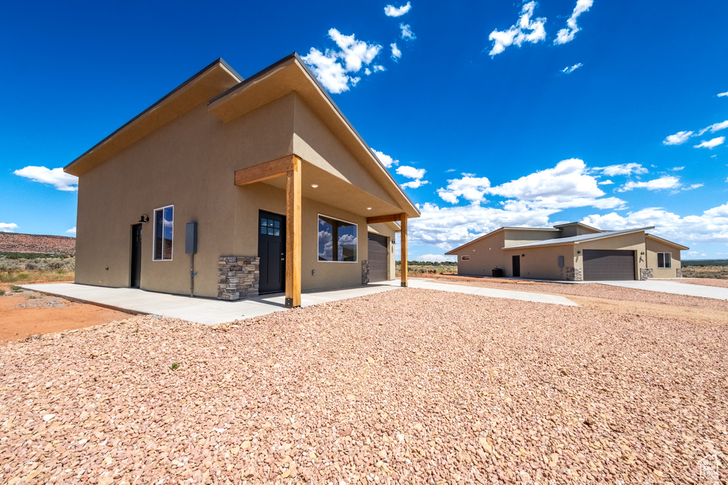 Back of property with a garage