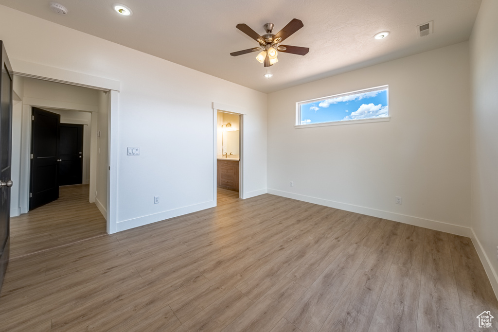 Interior space featuring hardwood / wood-style floors, ceiling fan, and ensuite bath