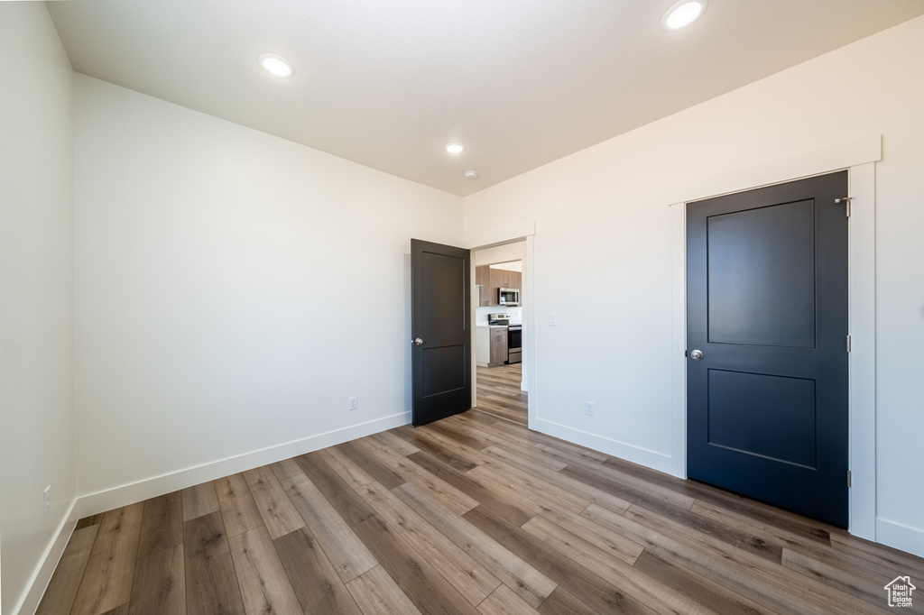 Unfurnished bedroom with wood-type flooring