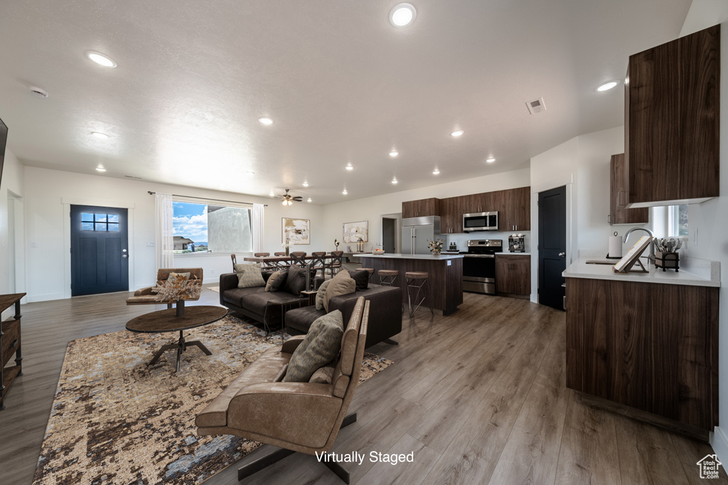 Living room featuring sink and light wood-type flooring