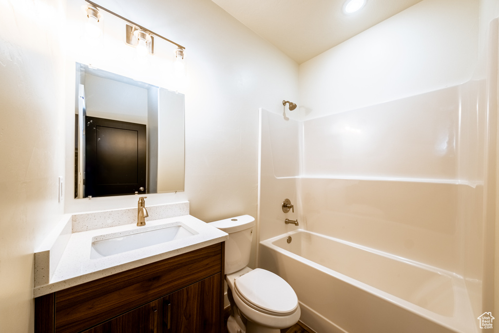 Full bathroom featuring shower / bath combination, toilet, and vanity