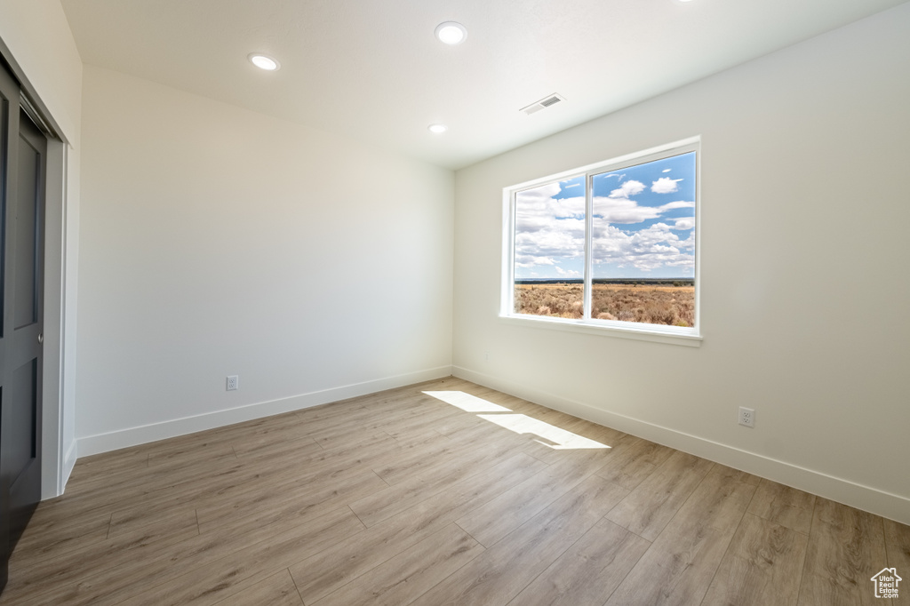 Unfurnished room featuring light wood-type flooring