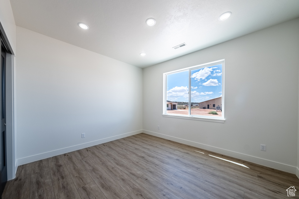 Spare room with hardwood / wood-style flooring