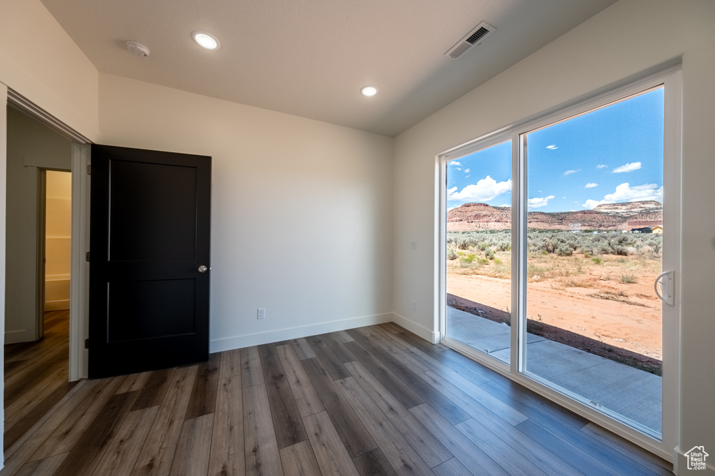 Interior space with dark hardwood / wood-style floors