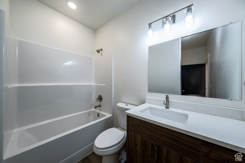 Full bathroom featuring vanity, toilet, and washtub / shower combination