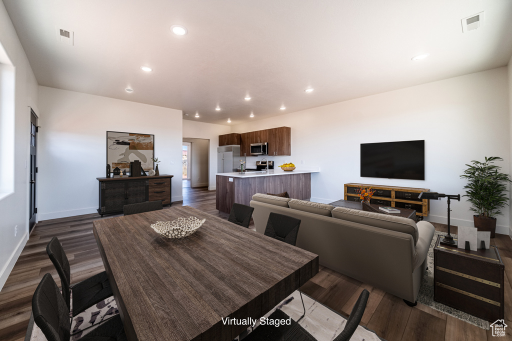 Dining space with dark hardwood / wood-style flooring