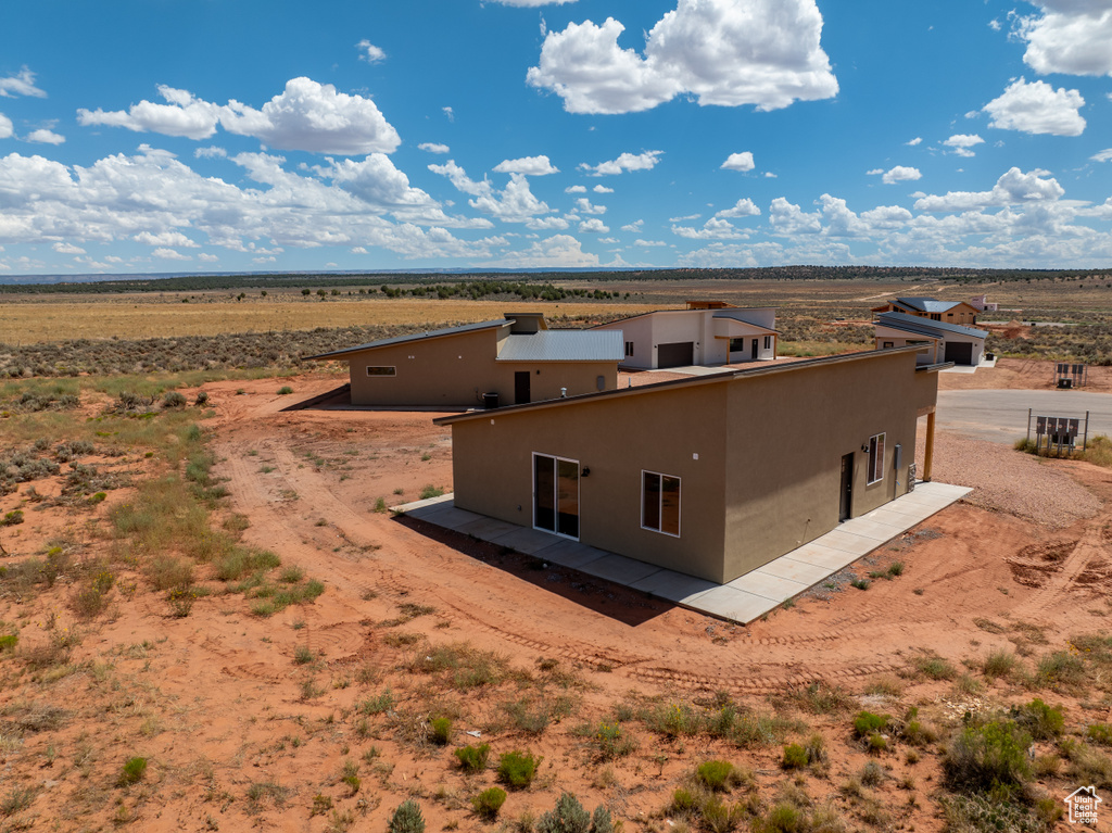 Back of house with a rural view