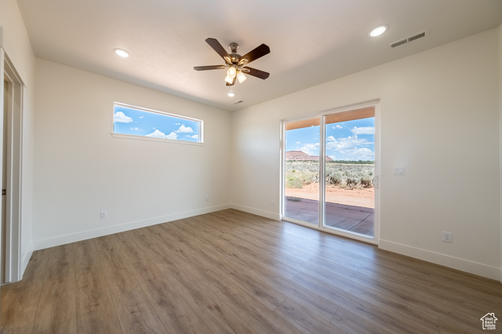 Spare room with ceiling fan and wood-type flooring