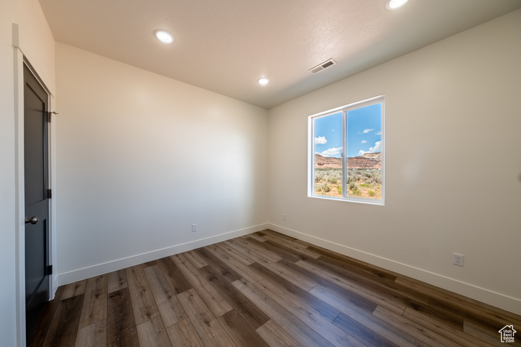 Empty room with dark hardwood / wood-style floors