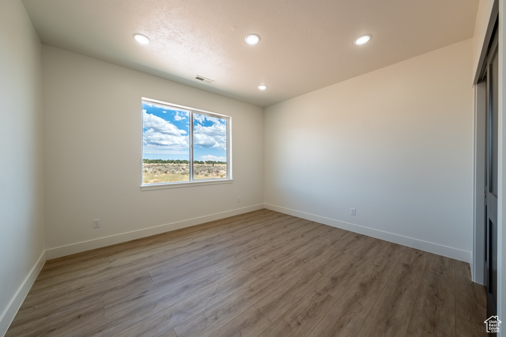 Empty room featuring wood-type flooring