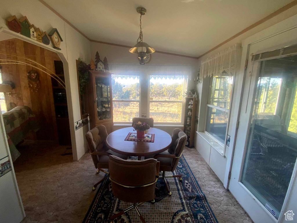 Dining area with vaulted ceiling and carpet floors