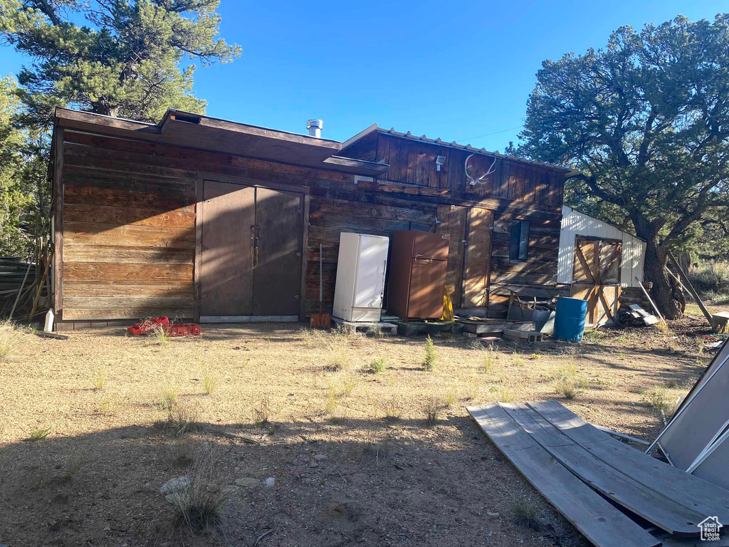 Back of house with a shed