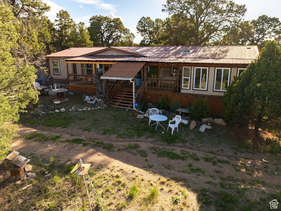 Back of house featuring a wooden deck