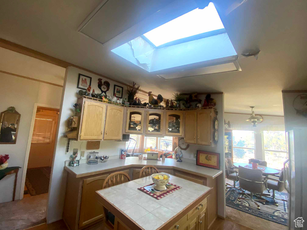 Kitchen with tile countertops and a skylight