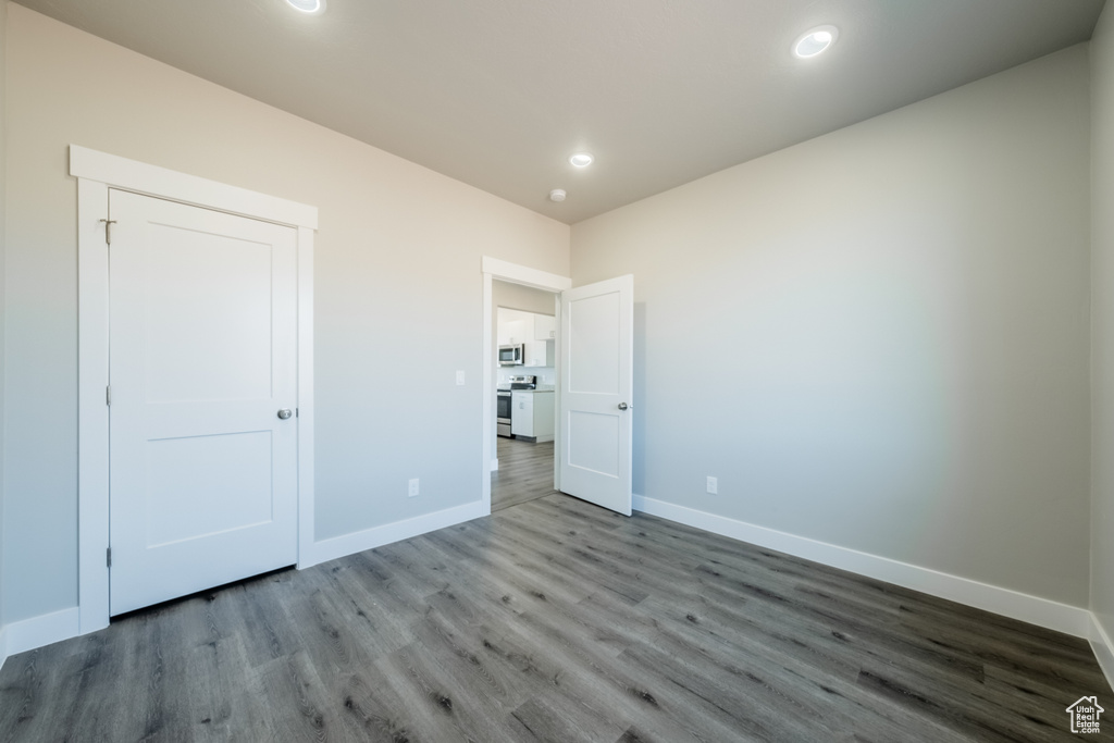 Unfurnished bedroom featuring wood-type flooring and a closet