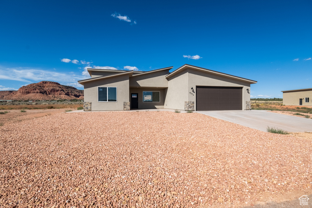 View of front of property featuring a mountain view and a garage