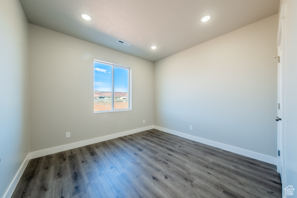 Unfurnished room featuring dark hardwood / wood-style floors