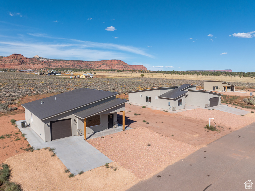 View of front of property featuring a mountain view and a garage