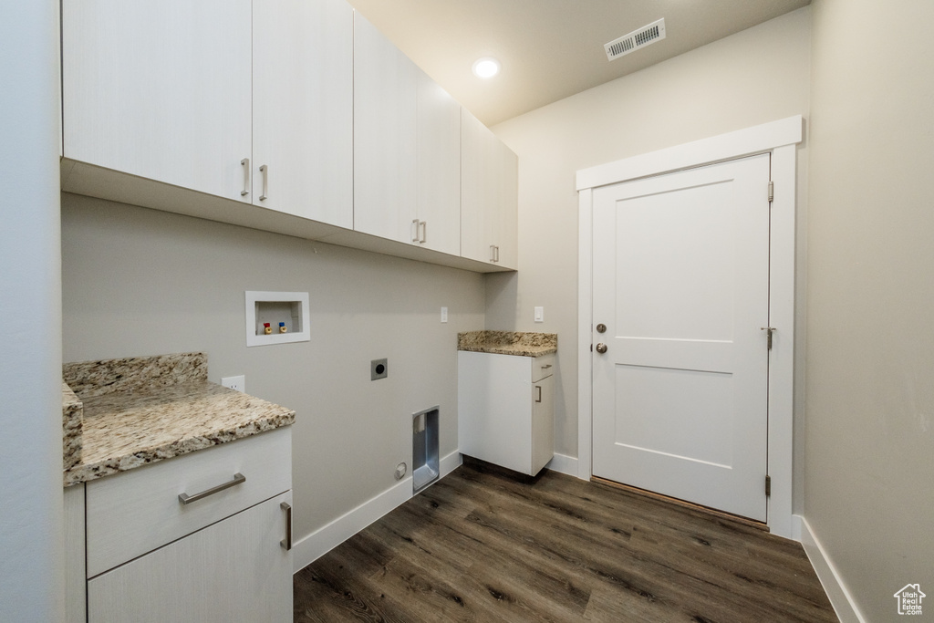 Laundry room with hookup for a washing machine, electric dryer hookup, cabinets, gas dryer hookup, and dark hardwood / wood-style floors