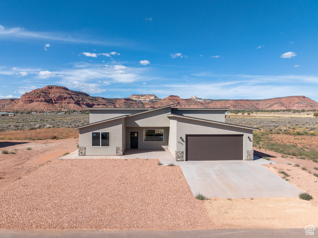 View of front facade featuring a mountain view and a garage