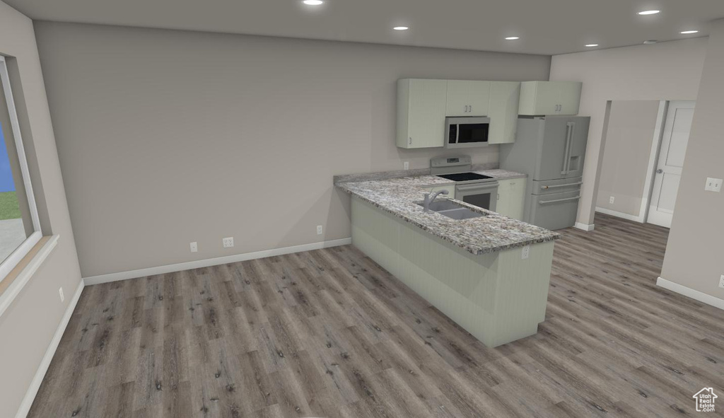 Kitchen with light stone countertops, kitchen peninsula, white appliances, light wood-type flooring, and sink