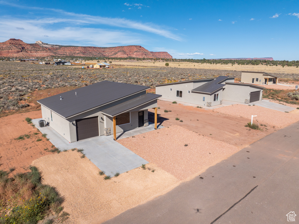 View of front of home featuring a mountain view and a garage