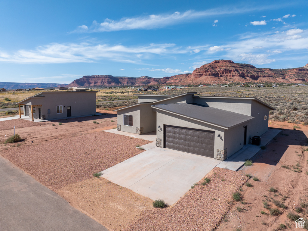 View of front of home featuring a mountain view and a garage