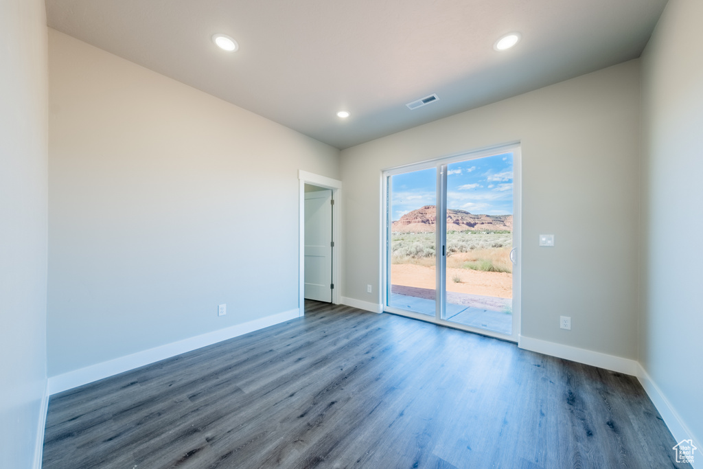 Spare room with dark hardwood / wood-style flooring