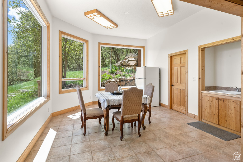 Dining space with sink and light tile flooring