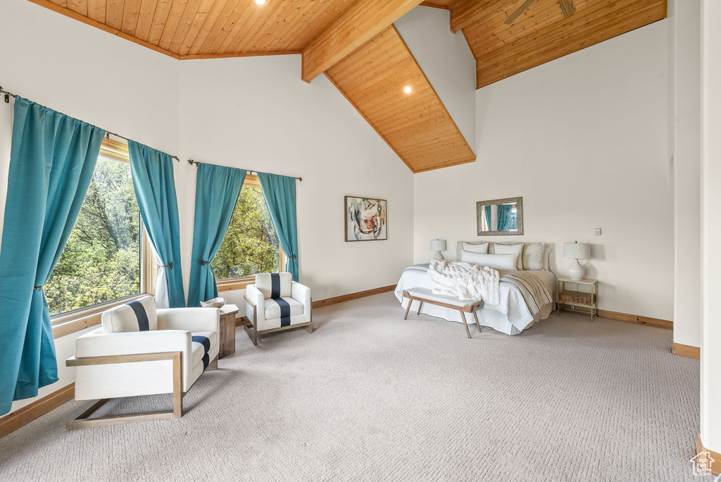 Bedroom with high vaulted ceiling, beam ceiling, carpet floors, and wooden ceiling