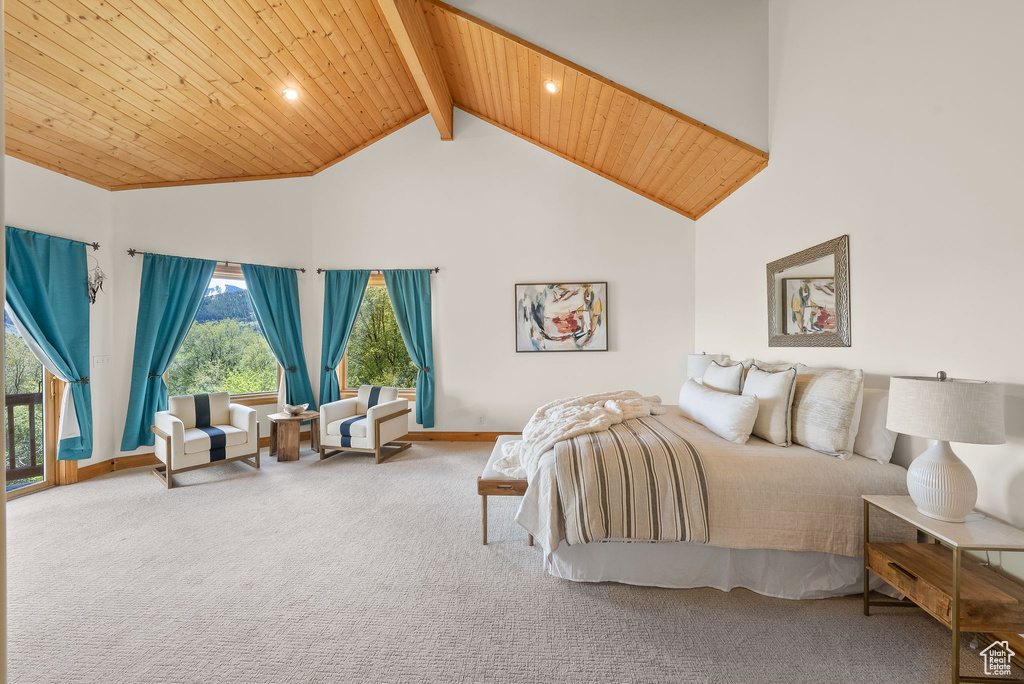 Carpeted bedroom with beam ceiling, high vaulted ceiling, and wooden ceiling