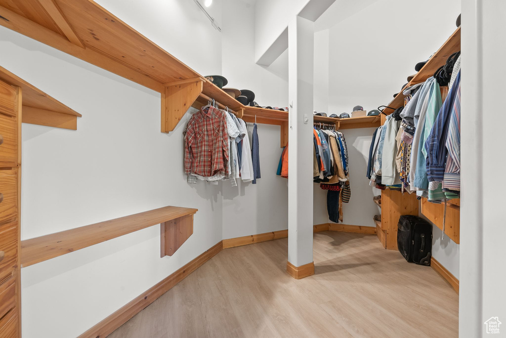 Spacious closet featuring light wood-type flooring