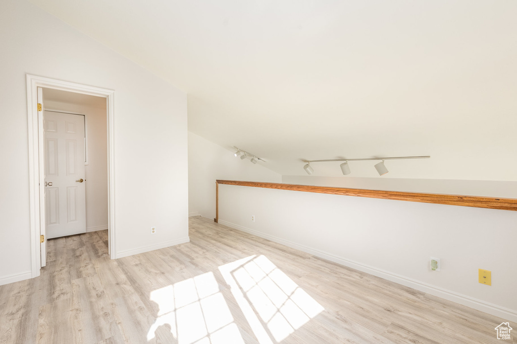 Unfurnished room with track lighting and light wood-type flooring