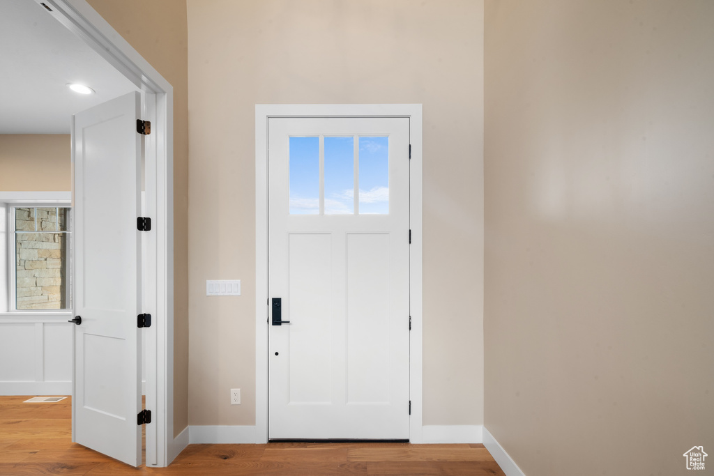 Foyer with light hardwood / wood-style floors