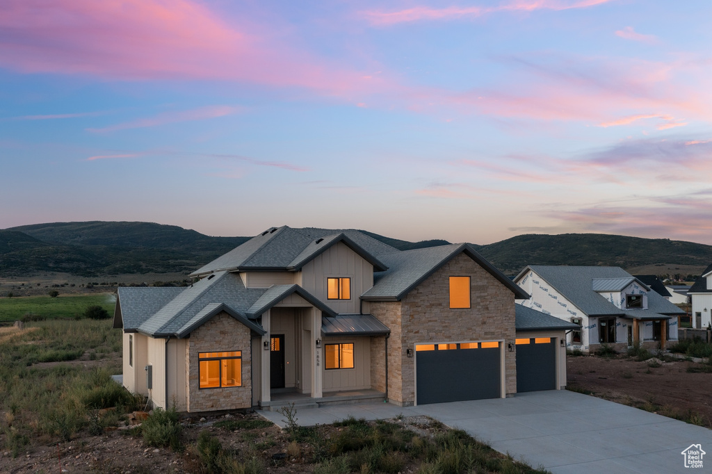 Modern farmhouse style home featuring a mountain view and a garage