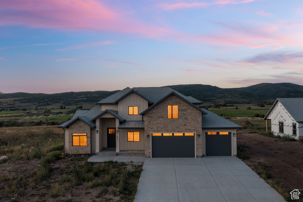 Modern farmhouse style home with a mountain view and a garage