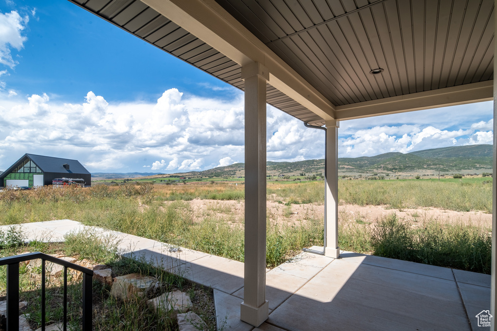 View of patio with a mountain view and a rural view