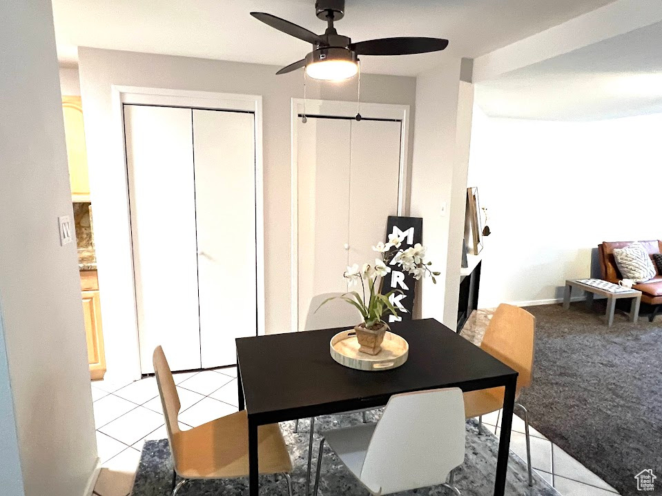 Tiled dining space with ceiling fan