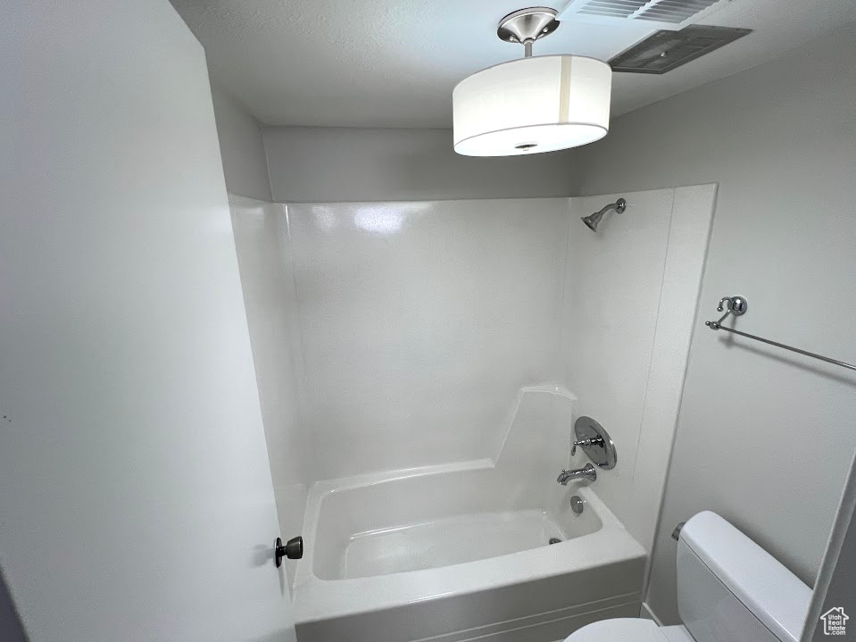 Bathroom featuring  shower combination and toilet