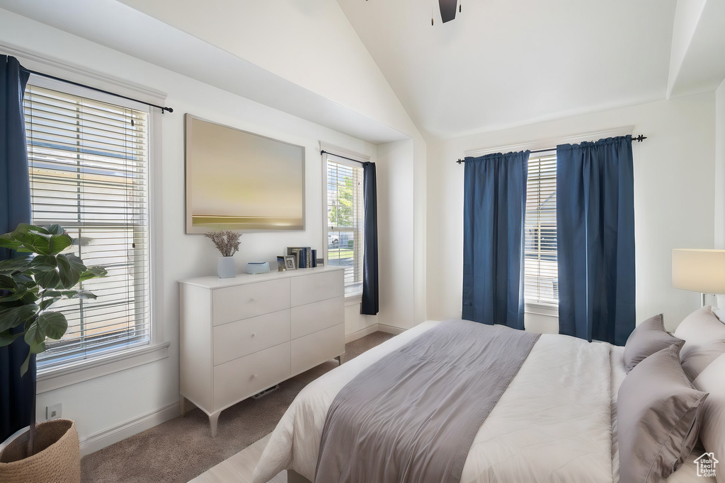 Bedroom with lofted ceiling, carpet, and ceiling fan