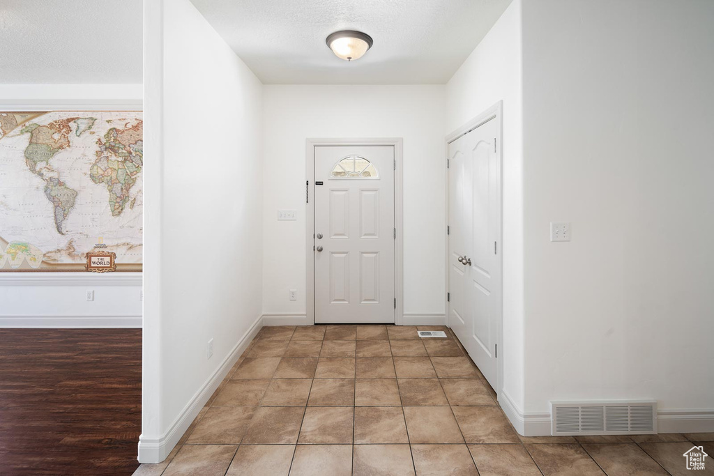 Foyer entrance featuring tile flooring