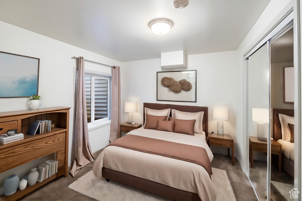 Carpeted bedroom with a closet