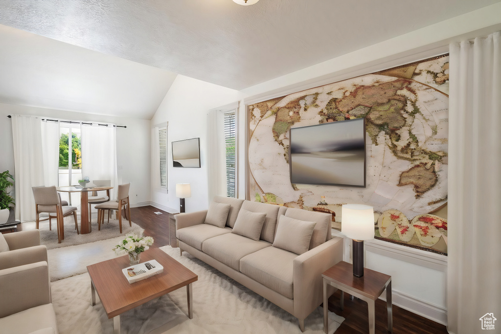 Living room with vaulted ceiling and wood-type flooring