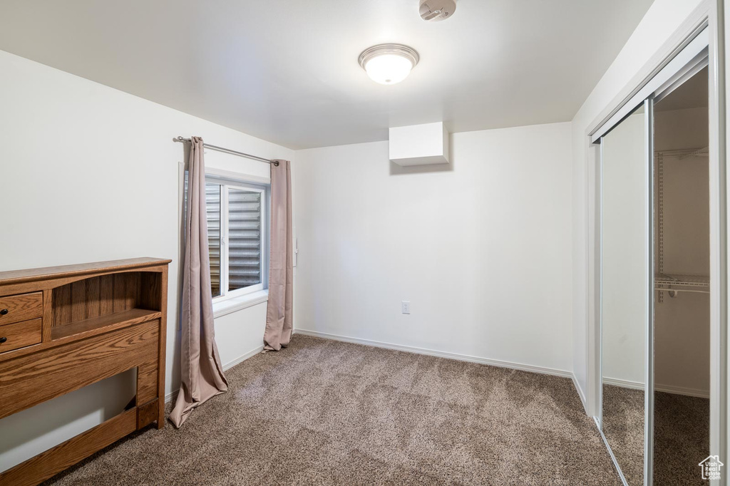 Bedroom featuring carpet flooring and a closet