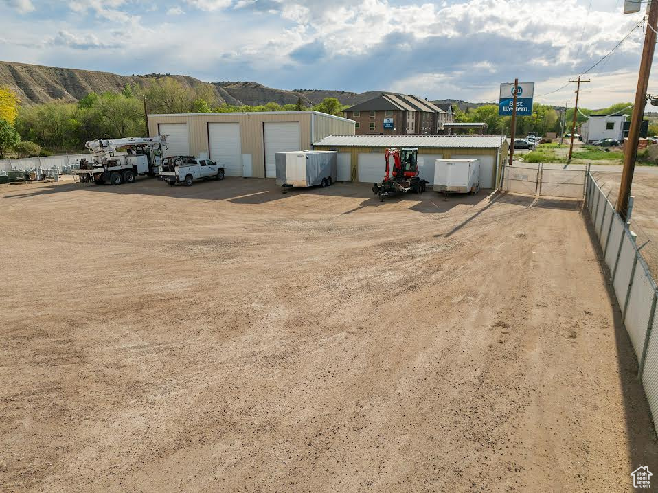 View of front of property with a garage, a mountain view, and an outdoor structure