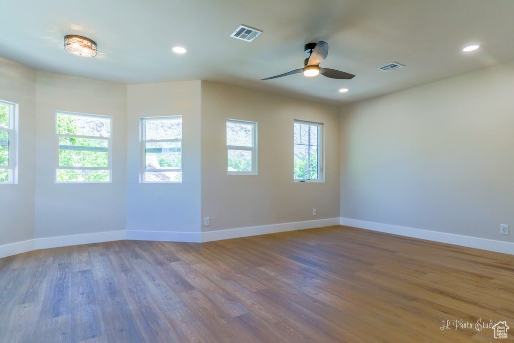 Unfurnished room with wood-type flooring and ceiling fan