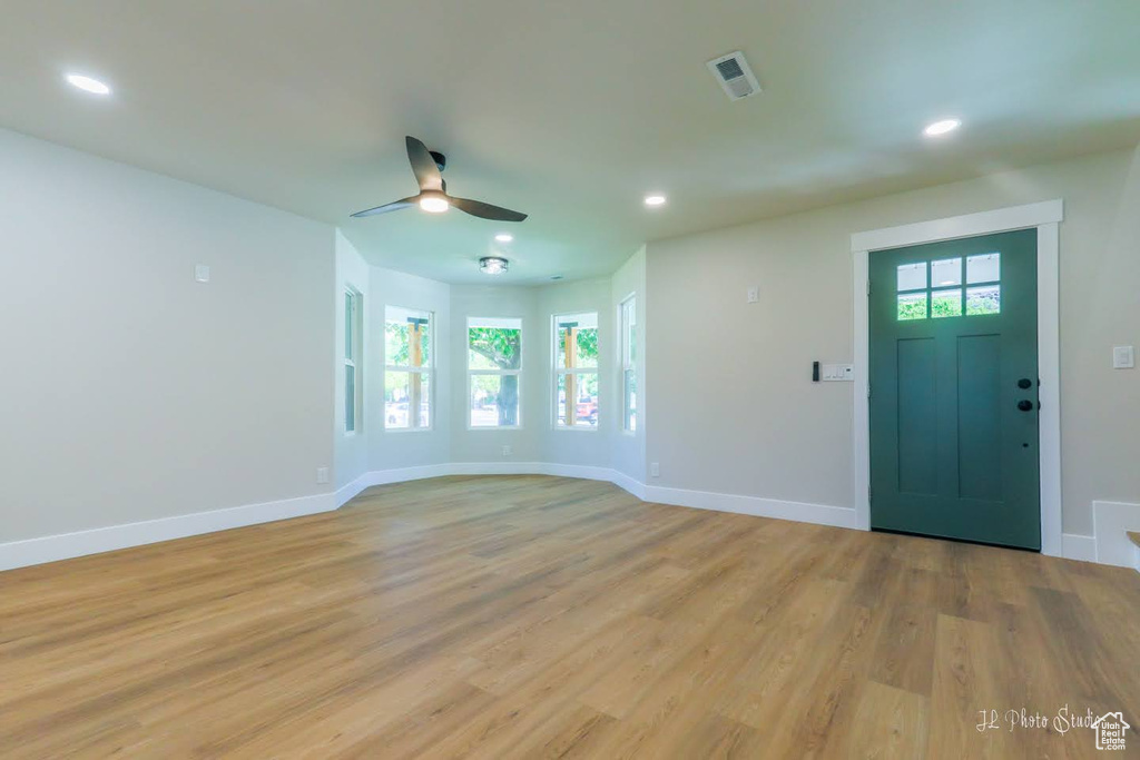 Entrance foyer with ceiling fan and light hardwood / wood-style flooring