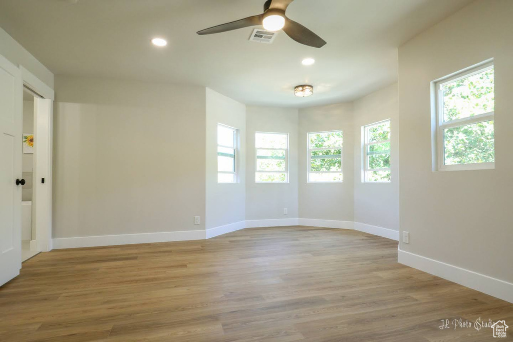 Spare room featuring ceiling fan and light wood-type flooring