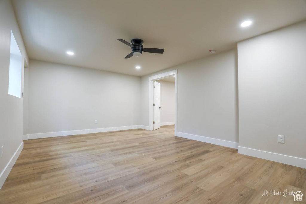 Unfurnished room with ceiling fan and light wood-type flooring